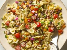 a bowl filled with pasta salad on top of a table