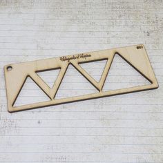 a wooden brochure with three triangles on it