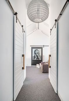 two pictures of an open door in a room with white walls and grey carpeting