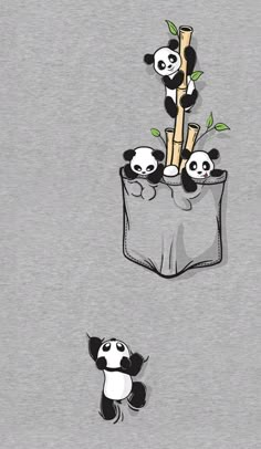 two pandas are sitting in the pocket of a t - shirt