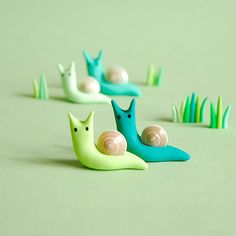 small plastic snails sitting on top of green grass