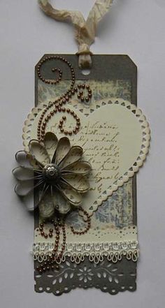 a card with a heart and flower attached to the back of it's tag