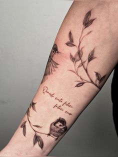 a woman with a tattoo on her arm that reads, and there is a bird sitting on the branch