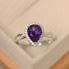 This ring features a 7*9 mm pear cut amethyst. Customization is available. It is made by hand, and it will take about 7 days to finish the ring after your payment is completed. Main stone: 7*9 mm pear cut Main stone weight:1.79 ct Metal type: sterling silver /14k gold Accent stone: cz Customization is available, just fee free to contact me, it is free to engrave inside the ring, it is free, you can leave a ntoe with your order, but it will be great no more than 15 letter. Any question, just let Pear Engagement Ring Halo, February Birthstone Ring, Original Engagement Rings, Engagement Ring Pear, Pear Cut Engagement Rings, Cute Engagement Rings, London Blue Topaz Ring, Pear Engagement Ring, February Birthstone