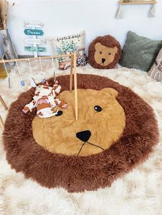 a lion rug is on the floor in a child's room with two stuffed animals