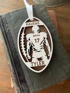 a wooden ornament with the name and number of a football player on it