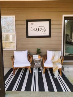 two chairs sitting on top of a black and white striped rug