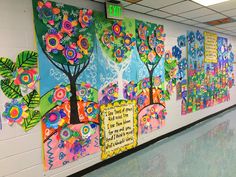 this is a hallway with colorful art on the walls and flowers painted on the wall