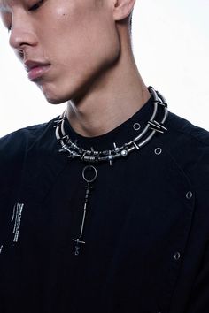 Experience the perfect fusion of futuristic aesthetics and industrial design with our Infiltrator Detachable Necklace. This unique necklace features an intricate chain composed of interconnected metal rings and spheres, creating a striking and modern look. The centerpiece is a detachable elongated pendant, adorned with small metal screws at each connection point, enhancing its industrial charm. This versatile pendant can be removed and worn as an earring, adding functionality to its bold style. Futuristic Accessories, Industrial Necklace, Detachable Necklace, Emo Style, Vampire Costume, Bold Style, Emo Fashion, Unique Necklace, Men's Accessories