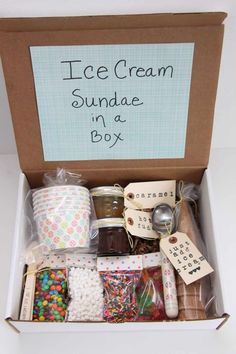 an ice cream sundae in a box is packed with candy and candies for the party