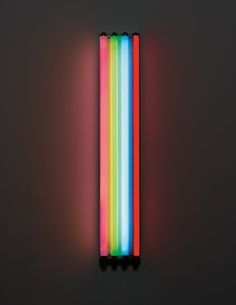 a multicolored object is lit up in the dark with light coming from it