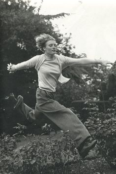 black and white photograph of a woman jumping in the air