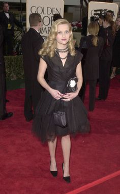 a woman in a black dress on the red carpet