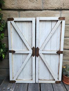 two white doors are open on a wooden table