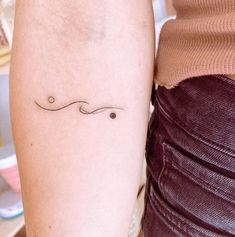 a woman's arm with a small tattoo on the left side of her leg