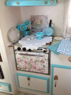 an old fashioned stove in the corner of a room with blue and white decor on it