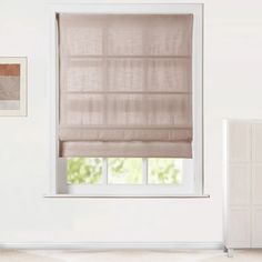 a white room with a window covered in blinds