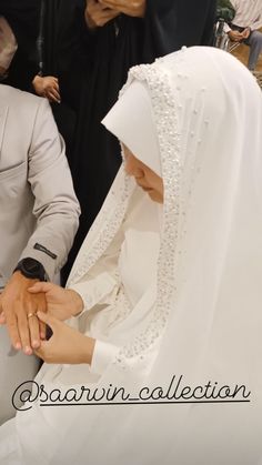 the bride and groom are holding hands together