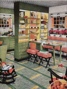 an old fashioned kitchen with green cabinets and chairs