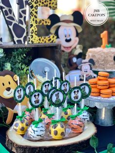 mickey mouse cake pops and cupcakes on a table