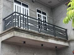 an apartment building with balcony railings and doors