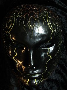 a mannequin's head is covered in yellow and black lightning bolts on it