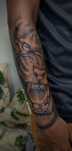 a man with a tiger tattoo on his arm