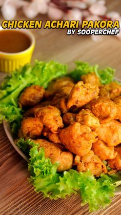 chicken achari pakora served with lettuce and sauce on the side