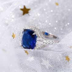 a ring with a blue stone surrounded by stars