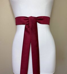 "Narrow Burgundy Dupioni Sash Burgundy Sash Belt Burgundy Dress Sash Burgundy Satin Sash Dupioni Fabric Belt Burgundy Wedding Satin Swank Add vibrant color and crisp texture to your special occasion outfit with this Satin Swank® dupioni waist sash. Depending on your waist size and the length you choose (75 and 90 inch lengths available), you can wrap this sash around your waist once or twice. You decide whether to tie the sash in a bow or a simple knot with long-hanging tails. Tie in front, in b Adjustable Bridal Belt With Sashes For Bridesmaid, Formal Fitted Sash With Tie Back, Formal Fitted Sash With Tie Waist, Adjustable Bridesmaid Bridal Belt With Sashes, Formal Adjustable Bridal Belt With Sashes, Formal Satin Bridal Belt With Sashes, Elegant Red Wedding Sash, Fitted Sashes Bridal Belt For Wedding, Burgundy Sash Belt