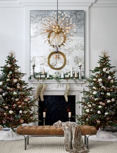 a living room decorated for christmas with white and gold decorations