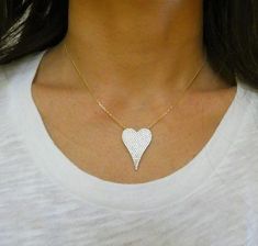 This is a pave heart necklace. Heart charm is encrusted in zircon gemstone sparkles and it's shape is elongated in a whimsical design. It is strung on a dainty, delicate chain. Beautiful worn solo or layered with other pieces! Makes a great gift!Available in 14k gold plated sterling silver and sterling silver. 3 different sizes: (NECKLACE CHAIN LENGTH is 16 inches with 2 inch extension)Large Heart Charm Measurements:Heart Charm: 1 inch longNecklace Length: 16 inches with 2 inch extension (same l Pave Heart Necklace, Zircon Gemstone, Crystal Heart Necklace, Mom Love, Dainty Choker, Heart Shaped Necklace, Heart Choker, Large Heart, Clover Earrings