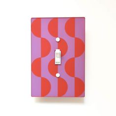 a pink and red wall plate with a single light switch on it's side