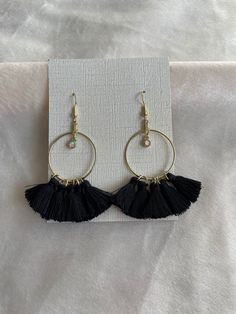 Black & Gold Tassel Hoop Earrings with a rainbow gemstone charm. Adjustable Tassel Drop Earrings, Black Dangle Hoop Earrings For Festivals, Trendy Black Earrings For Festivals, Black Tassel Jewelry For Festival, Trendy Black Festival Earrings, Tassel Dangle Hoop Earrings, Bohemian Black Metal Hoop Earrings, Trendy Adjustable Tassel Jewelry, Black Dangle Tassel Jewelry