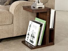 a living room with a couch, chair and book shelf on the floor in front of it