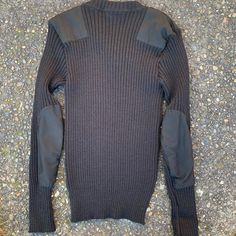 "Black Citadel military issue sweater. Size 42 men's. Excellent condition, almost unworn. 100% wool, thick, soft and stretchy. Clean and warm, classic style and made with quality and durability in England. - Model size men's large. Approximate measurements when laid flat: 18\" armpit to armpit 18\" shoulder to shoulder 22\" sleeve 28\" back of collar to hem" Military Style Cotton Sweatshirt For Winter, Military Style Adjustable Dad Hat, Black Ribbed Wool Sweater, Khaki Military Crew Neck Top, Fitted Military Wool Outerwear, Green Military Crew Neck T-shirt, Mens Knit Sweater, Pullover Sweater Men, Military Army