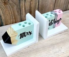 two wooden blocks with the word mrs and mr written on them, sitting next to each other