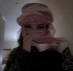 a woman wearing a headscarf covering her face