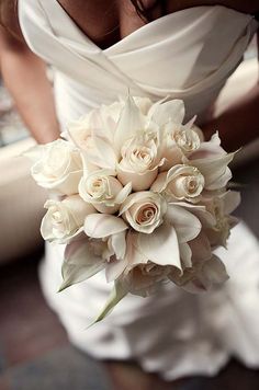 a bridal holding a bouquet of white flowers