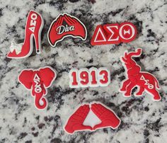 several red and white stickers sitting on top of a marble counter next to each other