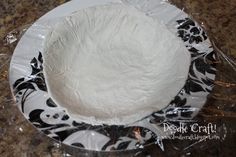 a white cake sitting on top of a plastic plate