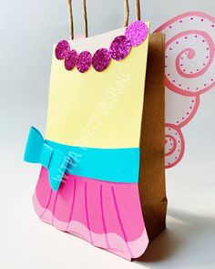 a paper bag with some pink and blue decorations on it