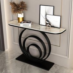 a console table with marble top and black metal frame, in a living room setting