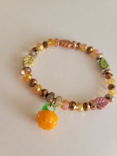 A super cute bracelet, perfect for fall with cute pumpkin charms and colors of the autumn leaves.  [These bracelets are made with a stretchy string, brown and orange glass beads, 4 different color leaf beads, and a pumpkin charm.] *The beads are small and lay nicely on your wrist, along with the leaf charm which is flat. The pumpkin charm is relatively small and does not have weight to it making it not uncomfortable to wear*  This bracelet is perfect for the fall season! Wear it to a pumpkin patch, with a cute cardigan or sweater look, or even for a fall festival! The colors go with the falling leaves on autumn day!  This wear includes a backing, stickers, and other little surprises. Your order is carefully packaged in a bubble mailer to protect it while in transit to your address. Handmade Multicolor Jewelry For Fall, Handmade Adjustable Jewelry For Fall, Adjustable Handmade Jewelry For Fall, Bracelets Fall, Leaf Beads, Cute Bracelet, Brown And Orange, Fall Theme, Leaf Bracelet