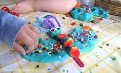 a child is playing with some toys on the table and it looks like they are made out of felt