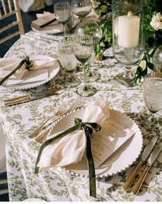 the table is set with place settings and silverware