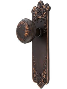 an antique style door handle with a decorative design on the front and back of it