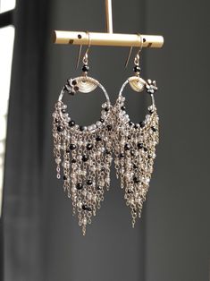 This tassel earring features a combination of black spinel and silver plated Labradorite, with a oxidized silver hoops in the middle and finely crafted textures. The other parts of the metal are matched with 14k gold-filled, and they shine together very brightly and have a gentle feeling, without putting any burden on the earlobes. ●black spinel ●silver plated labradorite ●oxidized silver ●14k gold filled ●mother of pearl flower ● total length: 3.58 inches ● weight：4.8g Welcome to visit my Jewelry store: https://www.etsy.com/shop/Ukuly 🌸The delivery time to Most regions of North America, Australia and Europe is usually about 10-15 days. Buyers from Brazil, South Korea, and Indonesia, please provide me with your tax number through messages or notes for smooth shipment. Thank you. 🌸Please Bohemian Dangle Earrings For Evening, Elegant Handmade Long Drop Tassel Earrings, Elegant Long Drop Handmade Tassel Earrings, Bohemian Dangle Chandelier Earrings For Evening, Bohemian Chandelier Dangle Earrings For Evening, Bohemian Evening Chandelier Dangle Earrings, Bohemian Fringe Earrings For Evening, Handmade Evening Chandelier Dangle Earrings, Bohemian Tassel Earrings For Evening