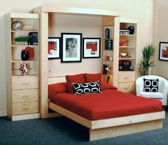 a bedroom with a bed, bookcases and pictures on the wall above it