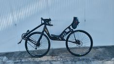 a bicycle parked against a wall in front of a building